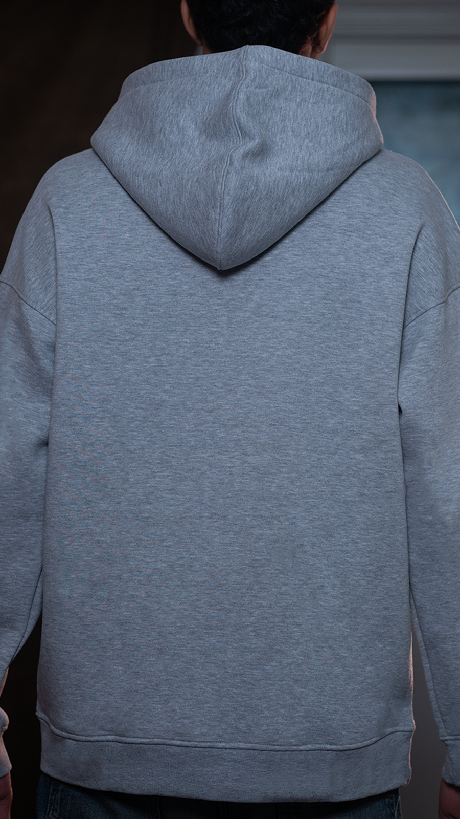 Person wearing a gray hoodie from behind