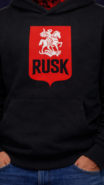 Black hoodie men with a red and white logo featuring a knight on a horse and the word 'RUSK'.