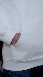 White hoodie For Men with one hand in the pocket.