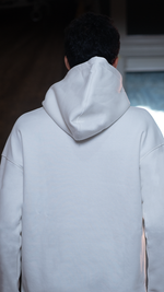 A White Hoodie For Men with a blurred background